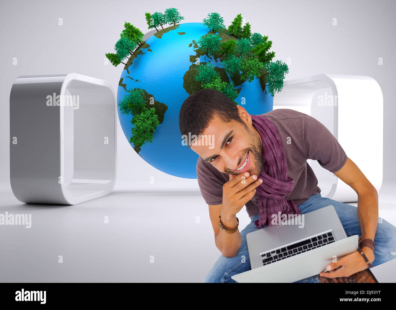 Composite image of thoughtful man sitting on floor using laptop and smiling at camera Stock Photo