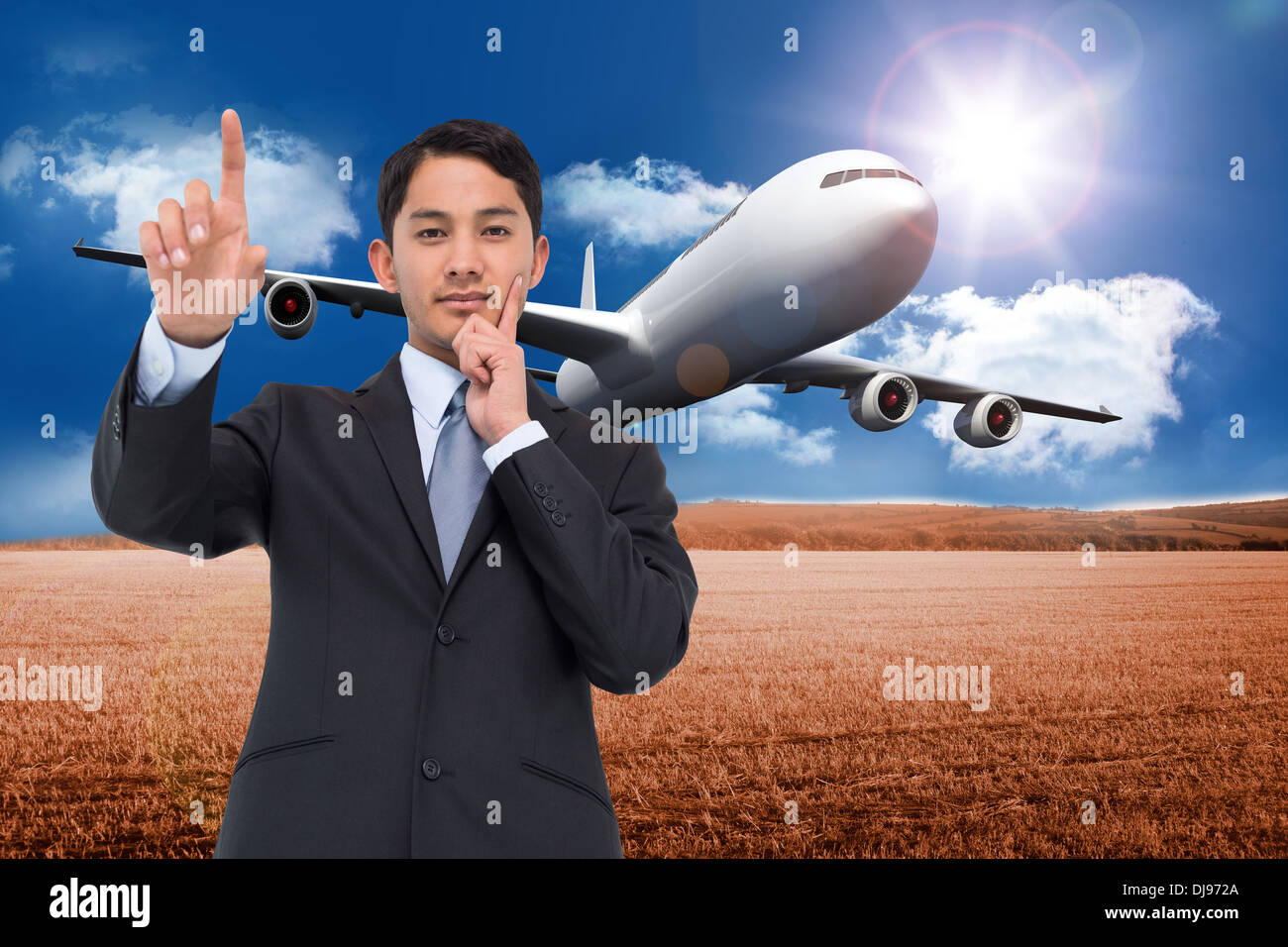 Composite image of thoughtful asian businessman pointing Stock Photo