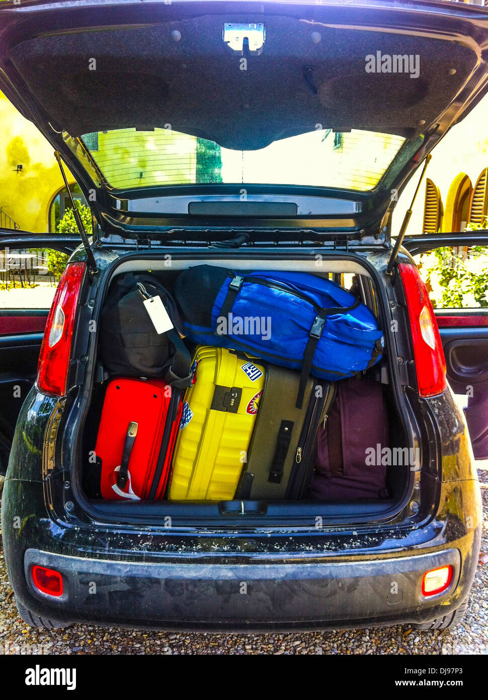 Luggage stuffed in car trunk Stock Photo Alamy
