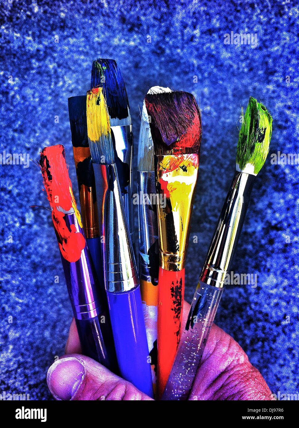 Painter holding dirty paintbrushes - Smartphone Captured Stock Image