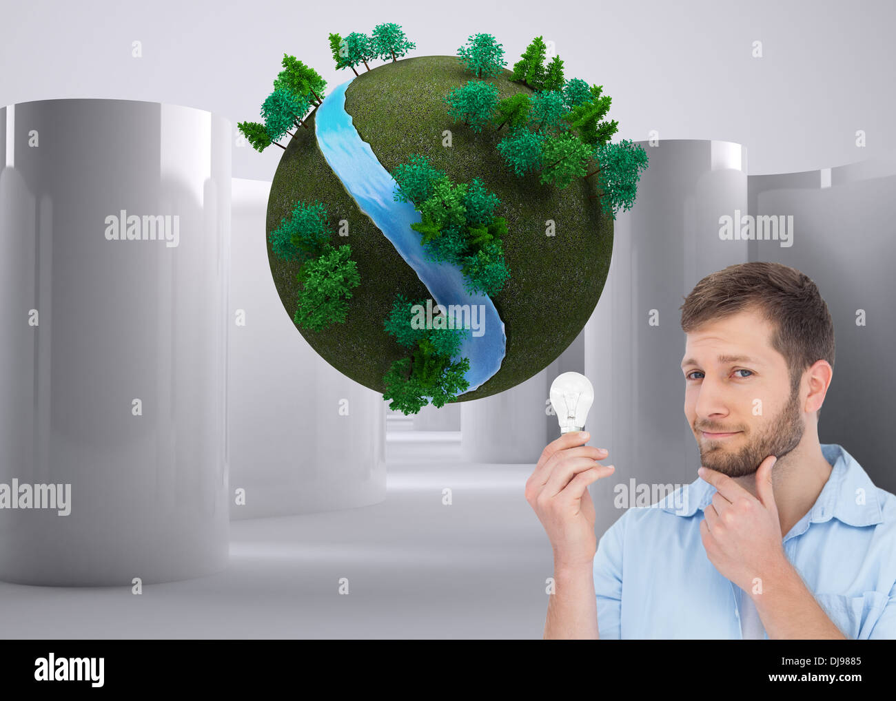 Composite image of handsome model holding a bulb Stock Photo