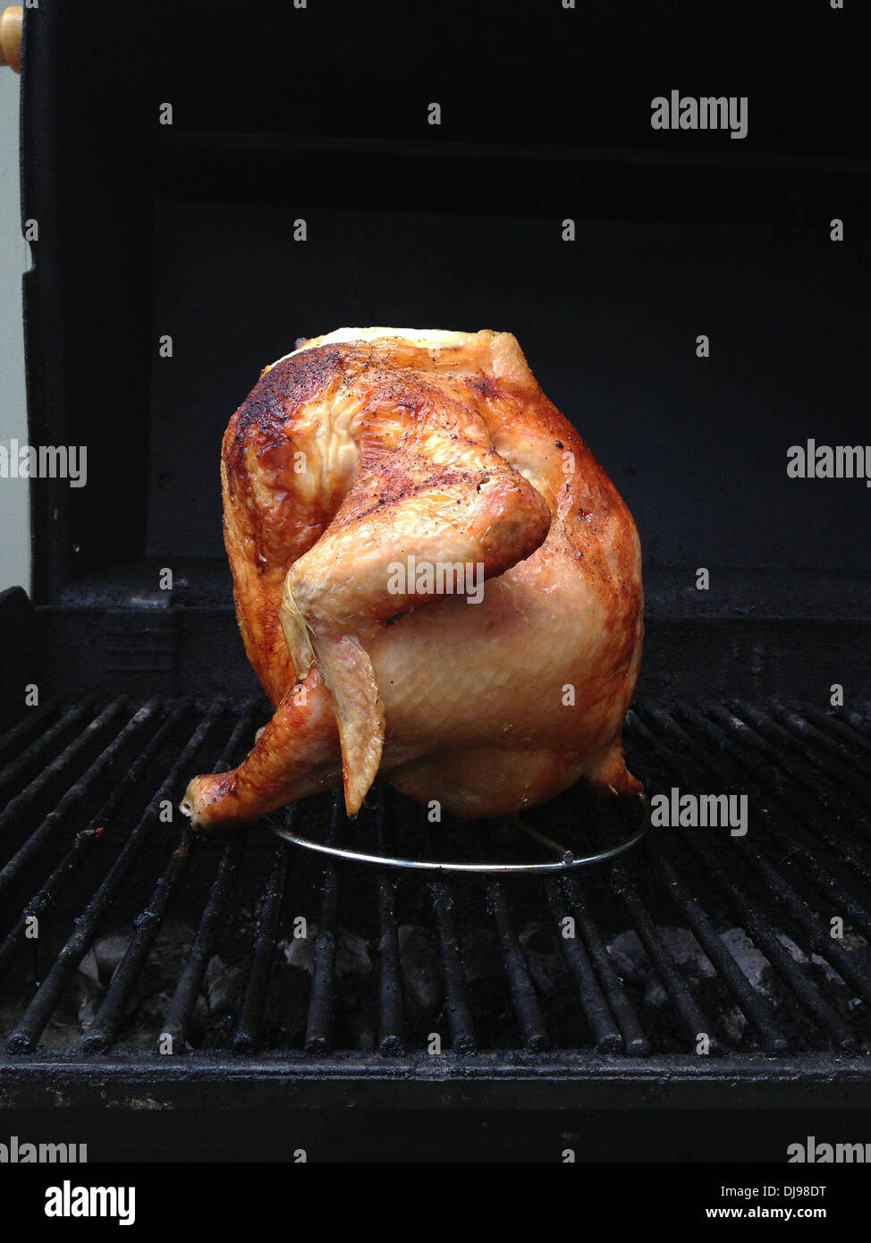 Beer can chicken sitting on grill - Smartphone Captured Stock Image
