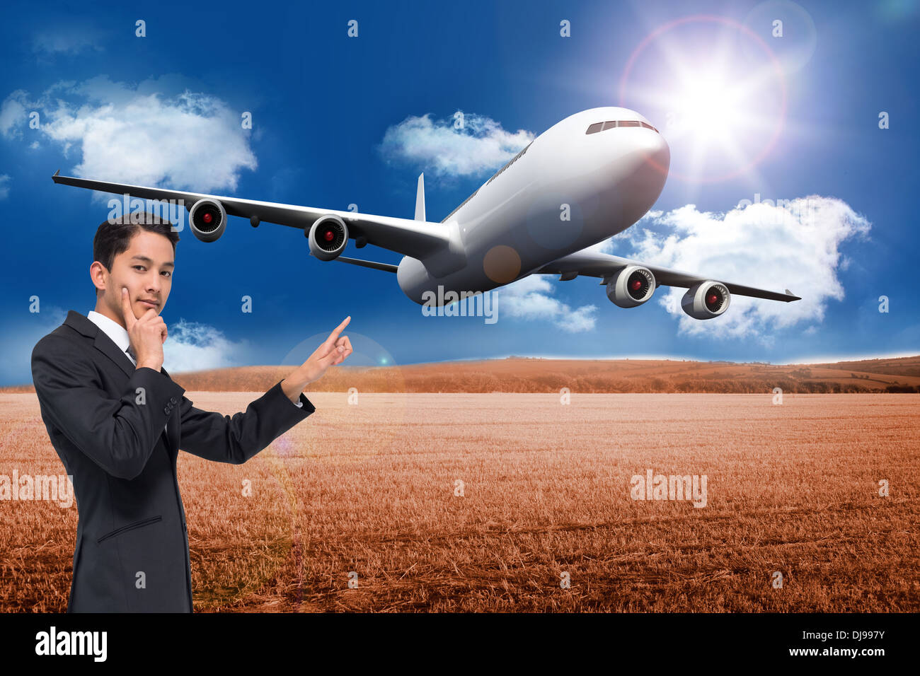 Composite image of thoughtful asian businessman pointing Stock Photo