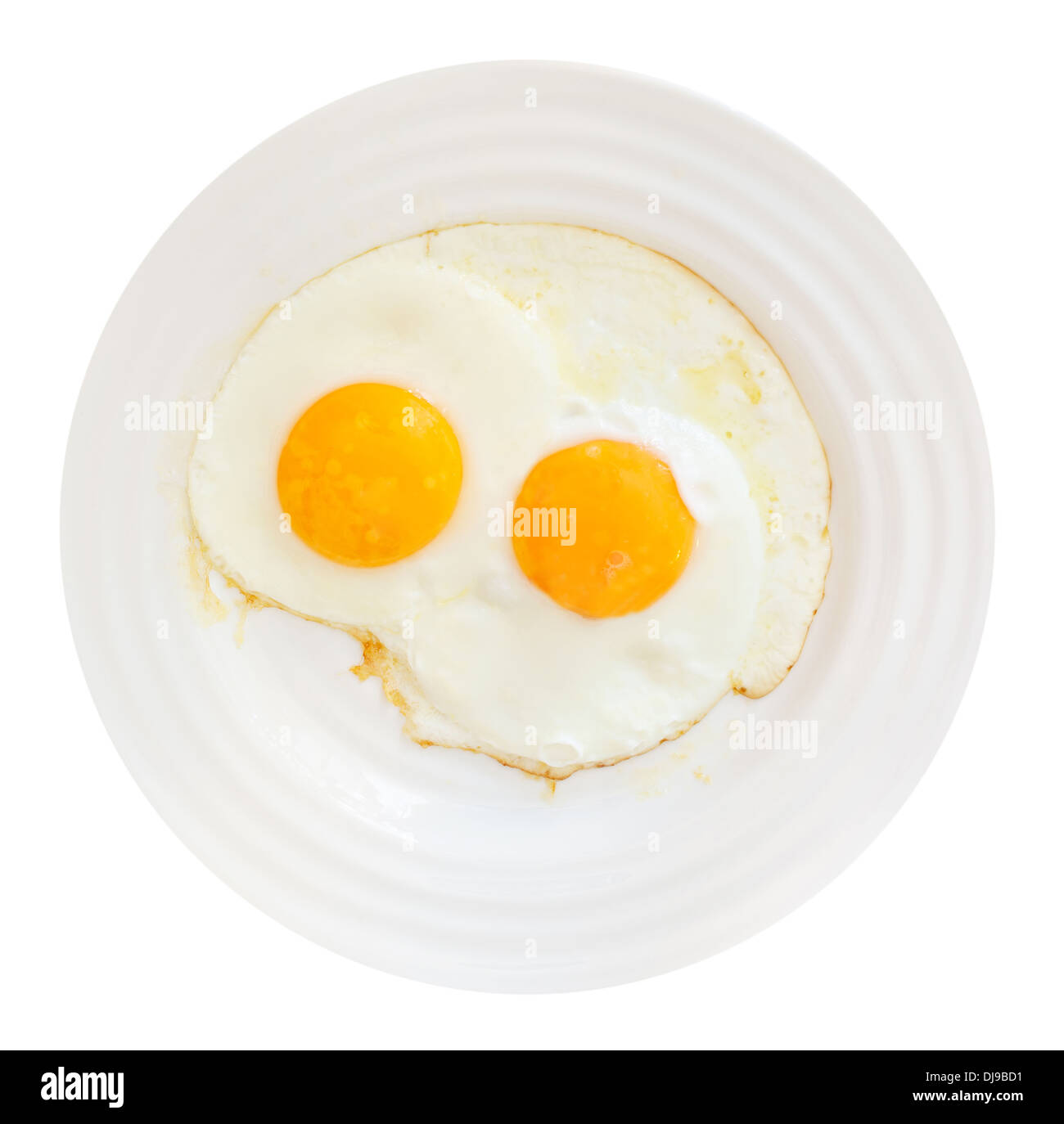 top view of white plate with two fried eggs isolated on white ...