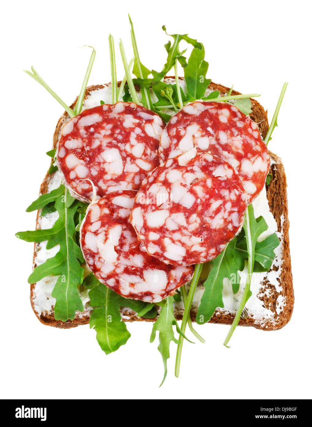 sandwich from rye bread, cottage cheese, salami and rocket salad isolated on white background