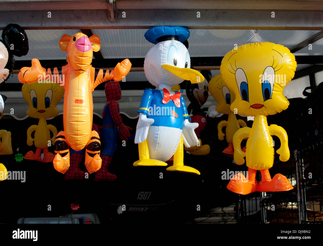 Inflatable cartoon characters on sale outside a shop Stock Photo