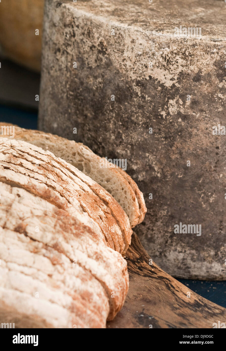 Detail view of artisan Cheddar cheese, and sour dough bread. Used for making toasted cheese sandwiches. Stock Photo
