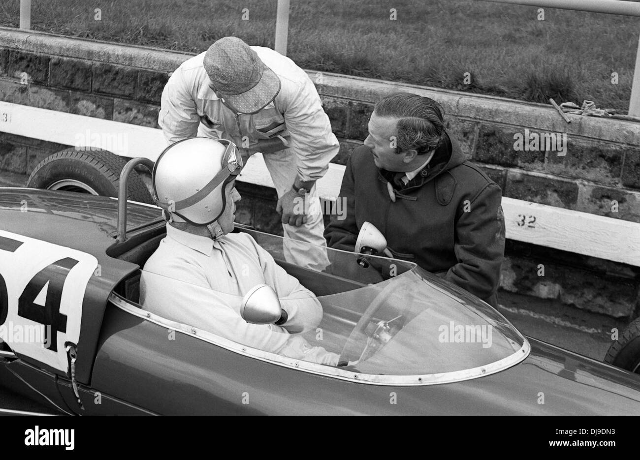 Colin Chapman with Jim Russell in a Lotus 20 Formula Junior in the XVI BARC Aintree 200 race. England 22 April 1961. Stock Photo