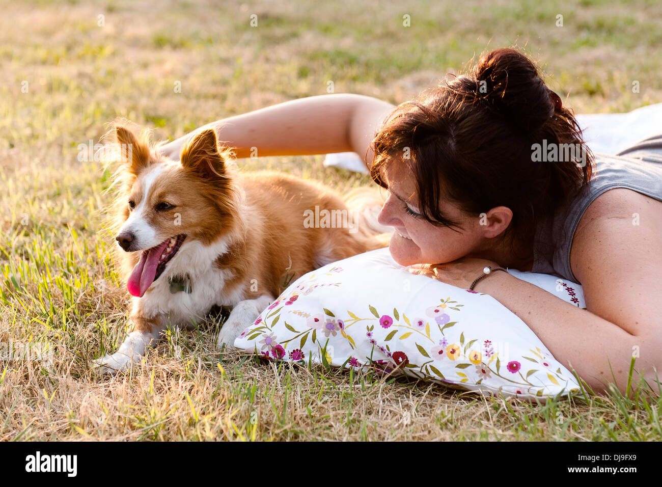 young woman with dog at park Stock Photo