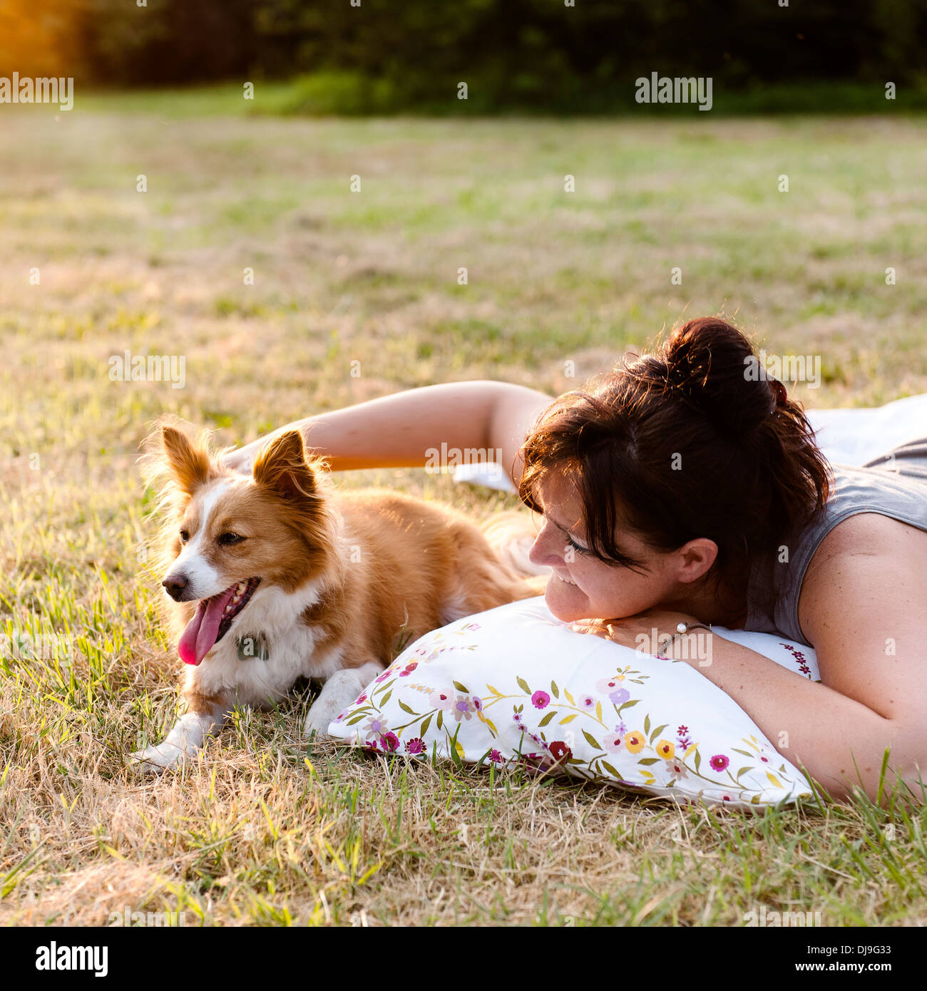 Young woman at park with her dog Stock Photo
