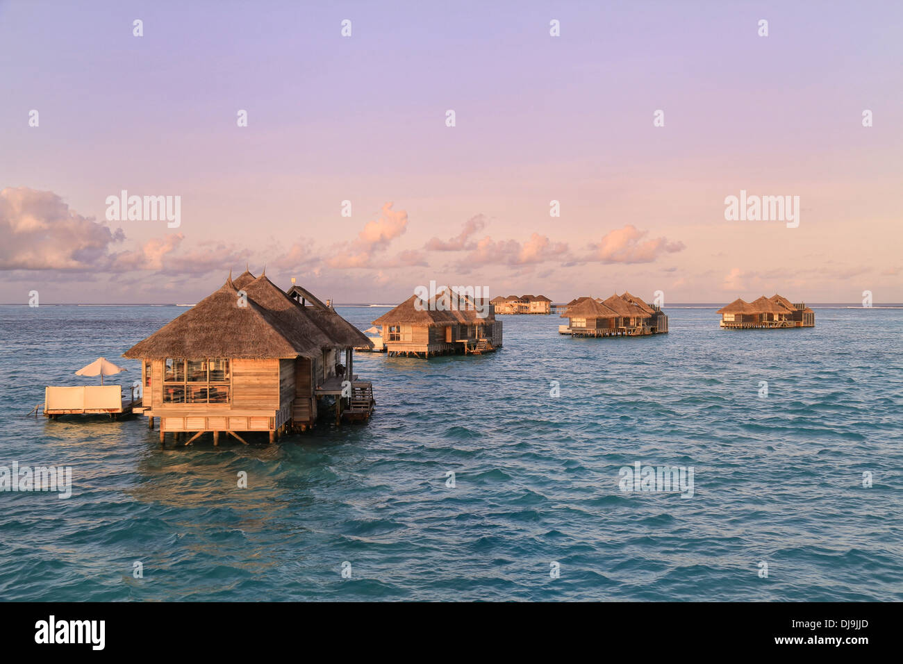 Crusoe Villas at Gili Lankanfushi (formerly Soneva Gili) in the Maldives at sunset under a purple evening sky Stock Photo