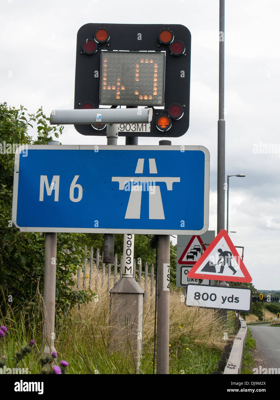 Speed, roadworks and traffic queue signs at entrance to M6 motorway, Birmingham, UK Stock Photo