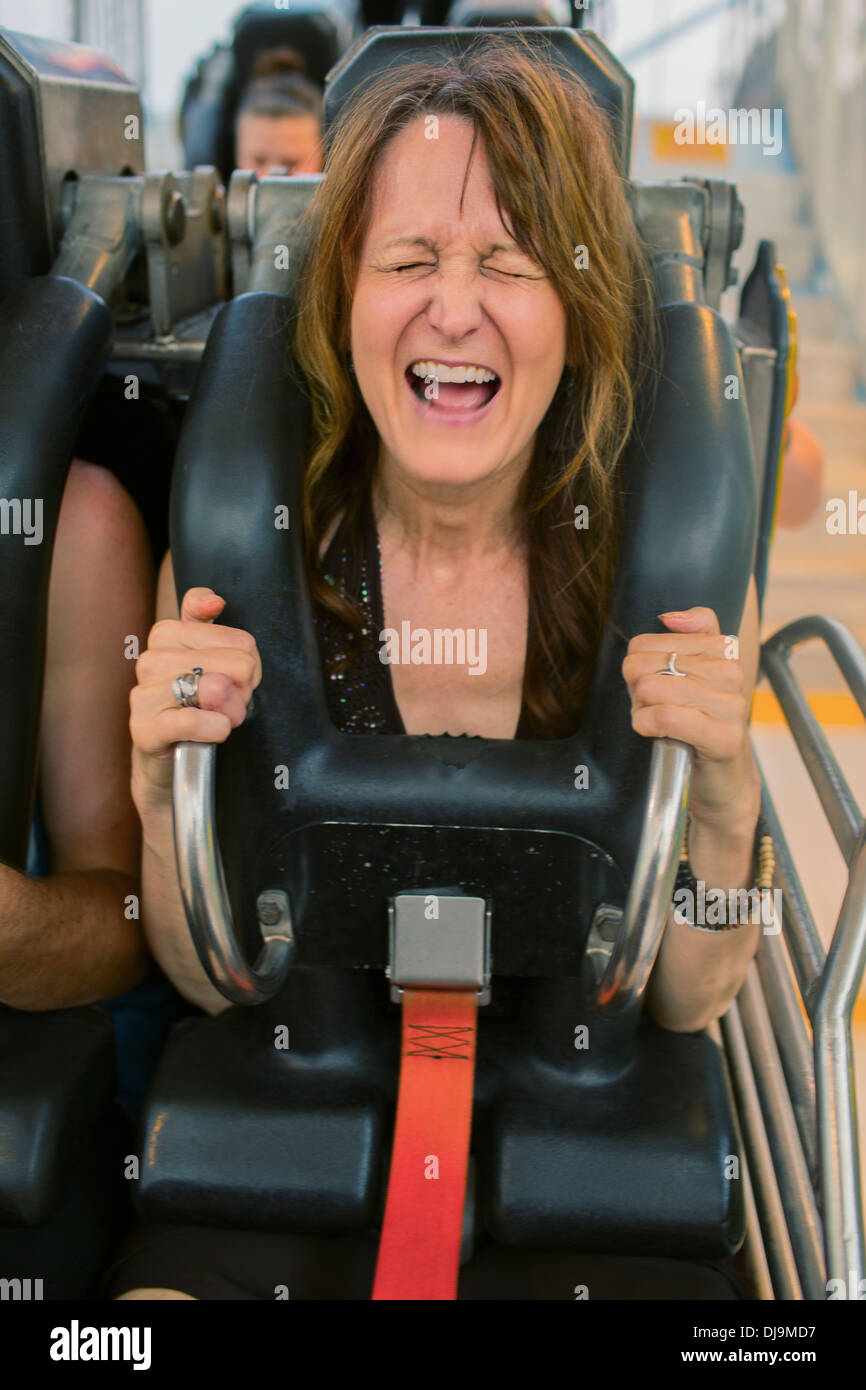 Caucasian woman shouting on roller coaster Stock Photo Alamy