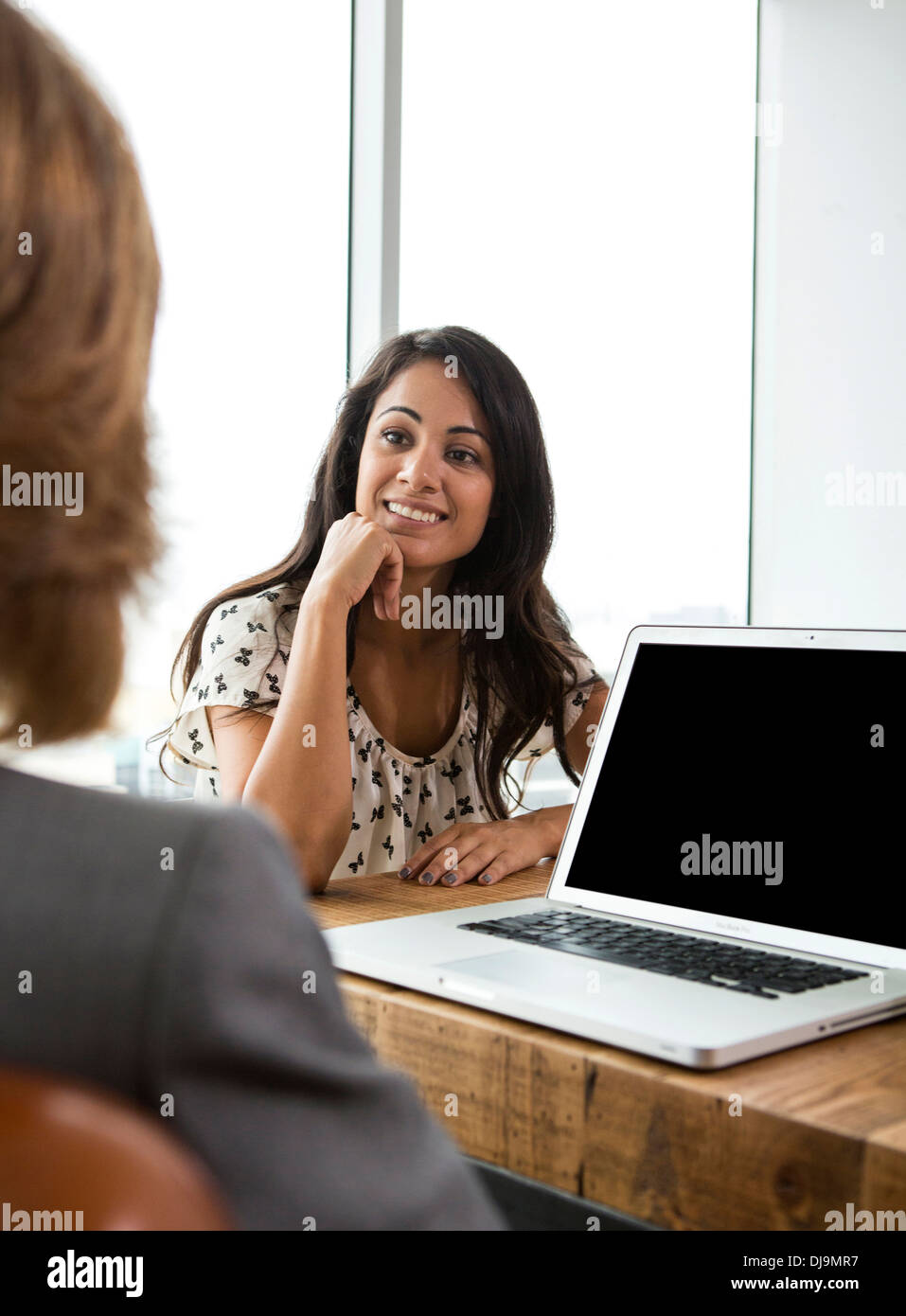 Businesswomen talking in office Stock Photo