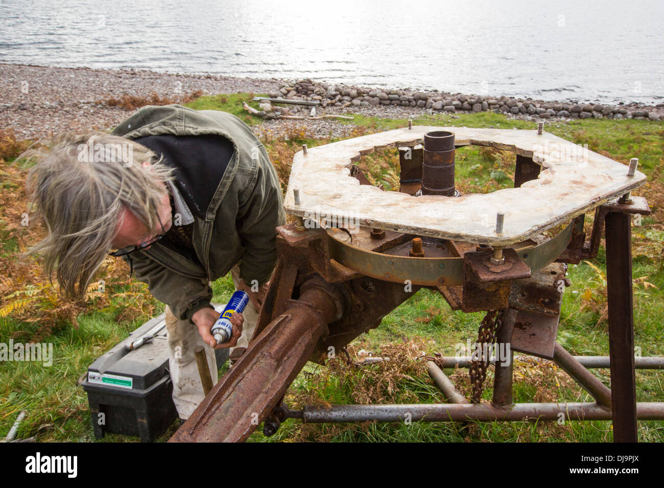 Hugh Piggott doing maintenance on his home made wind turbines in Scoraig, in NW Scotland, one of the most remote communities Stock Photo