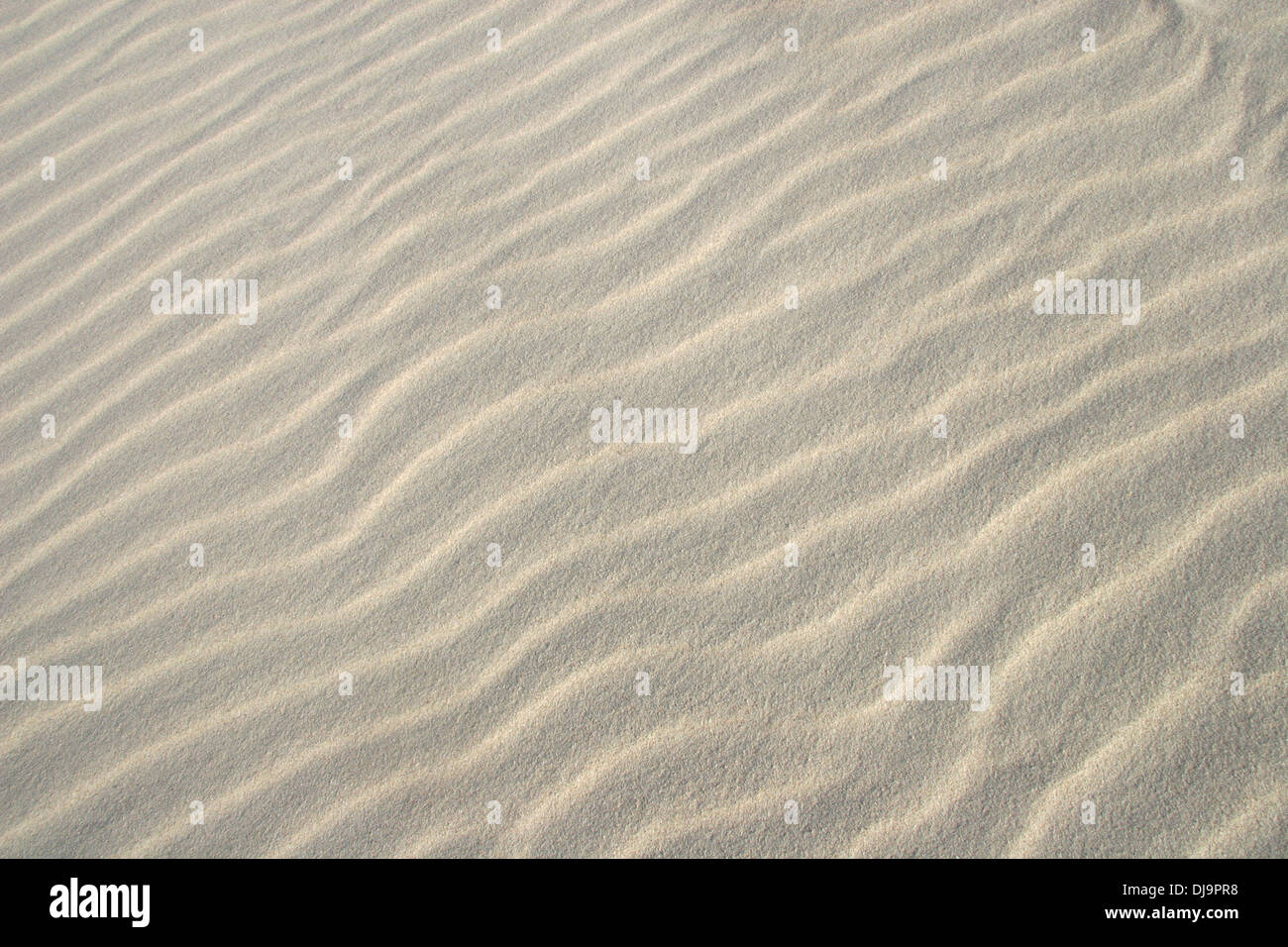 Close up of sand on a beach, showing the natural ripples. Stock Photo