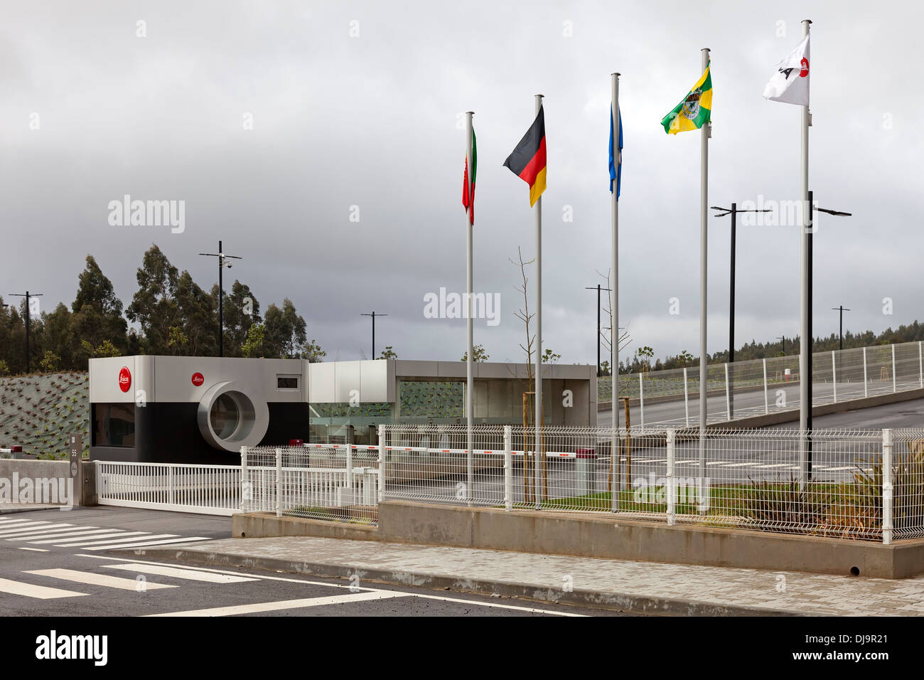 The flags of Portugal,  Germany, EU, Vila Nova de Famalicão city and Leica floating on the new Leica factory in Portugal. Stock Photo