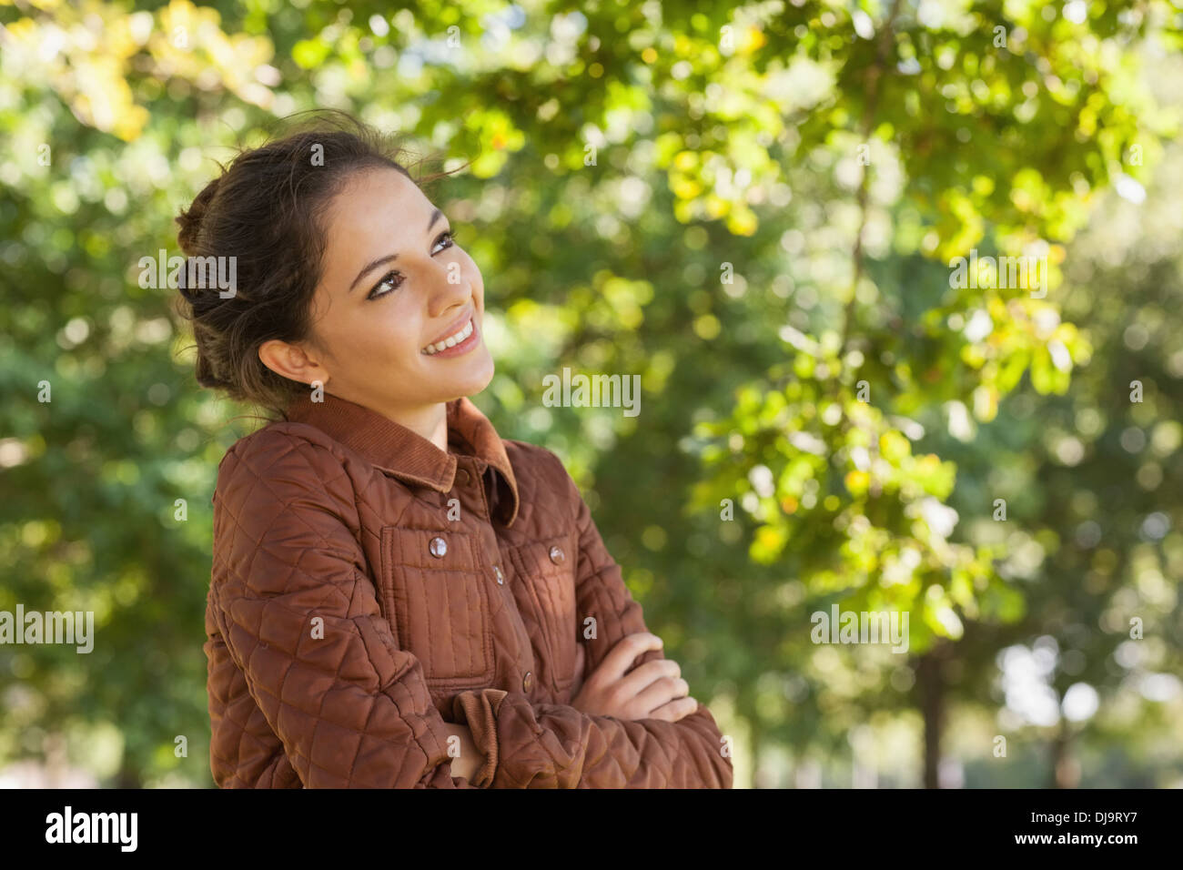 Lovely young woman wearing a brown coat posing Stock Photo - Alamy