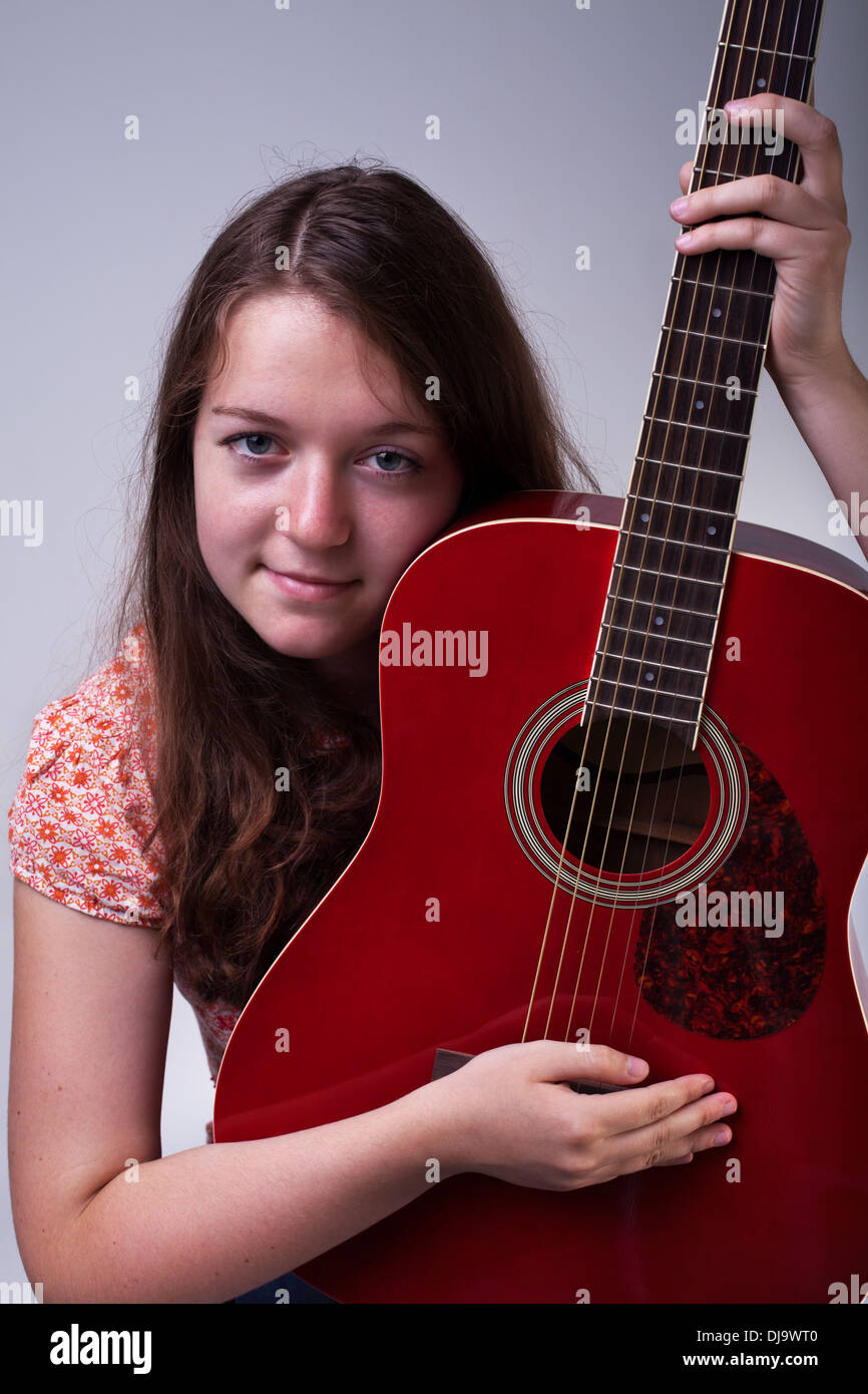 Young teenage girl with red guitar portrait Stock Photo