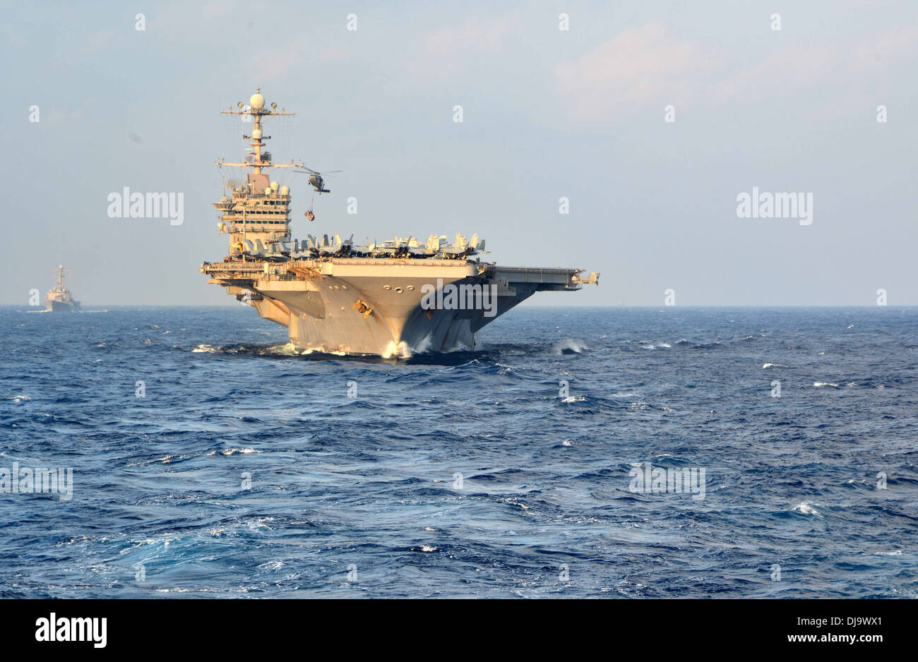 aircraft carrier USS George Washington (CVN 73) steams towards the Military Sealift Command dry cargo and ammunition ship USNS Stock Photo