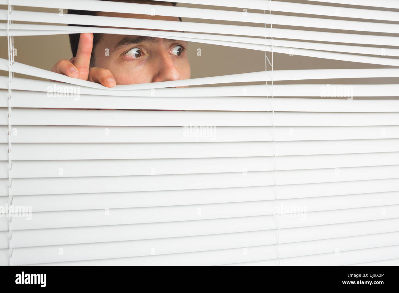 Scared male eyes spying through roller blind Stock Photo - Alamy, image size:1300x956
