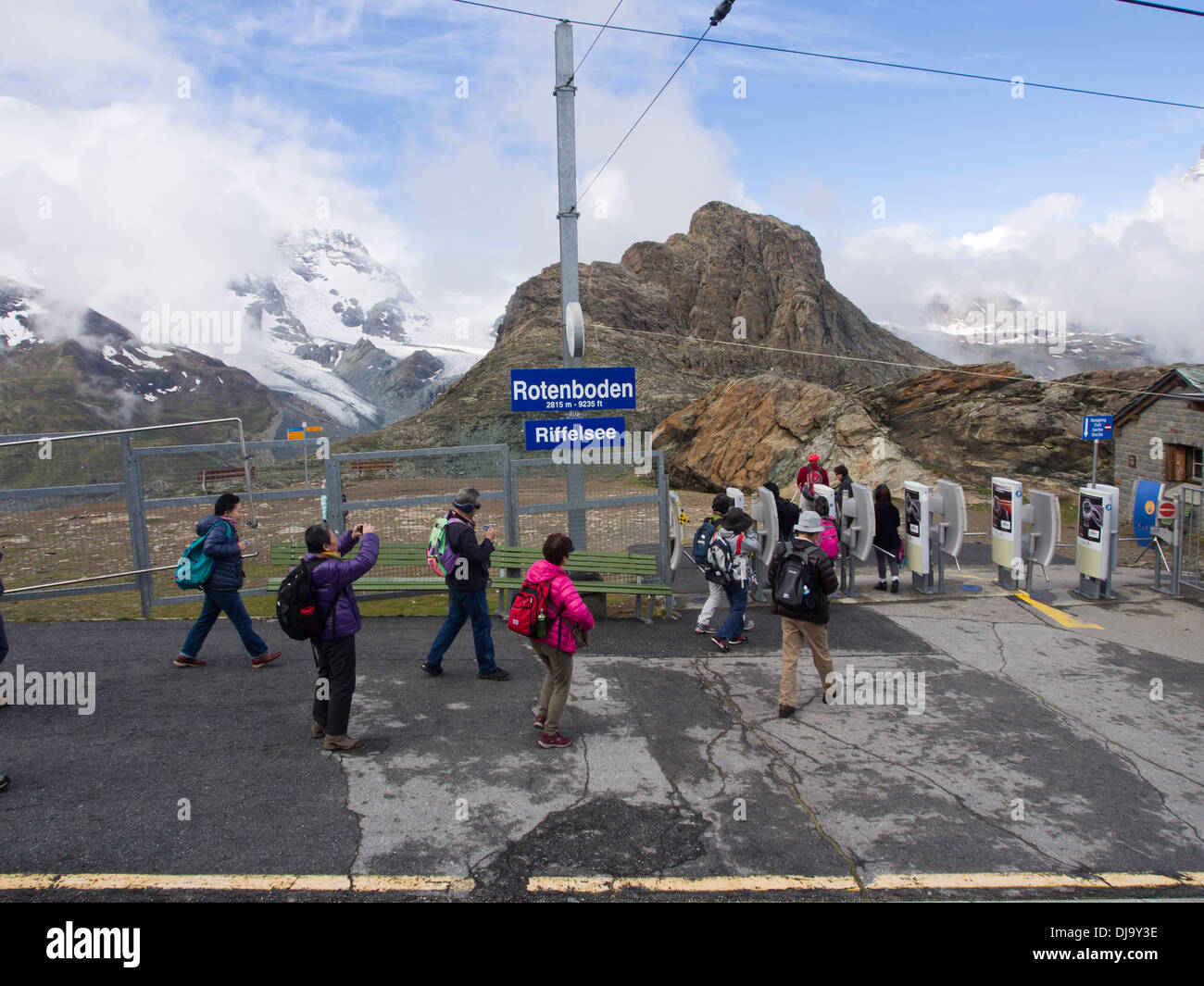 Asian tourists and hikers alighting the Gornergrat Bahn a cogwheel or rack railway in Switzerland  at the Rotenboden station Stock Photo