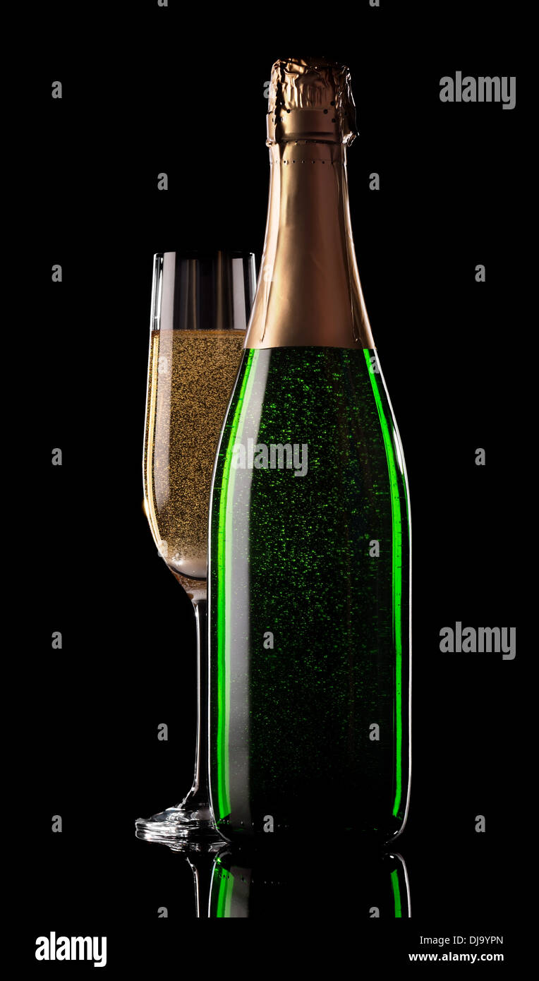 Glass and bottle of champagne on a black background Stock Photo