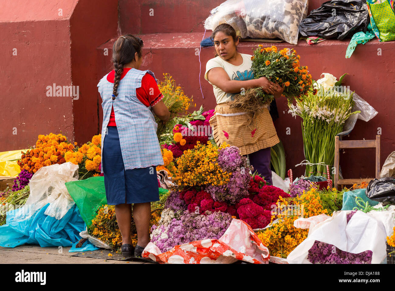 Mexican women selling flowers used for honoring gravesides for the Day