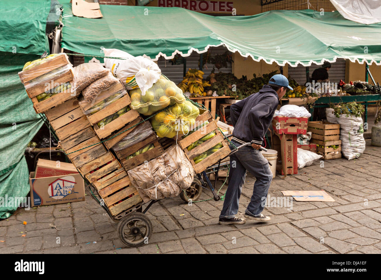 An worker moves carts of fresh fruit at the Benito Juarez Market in