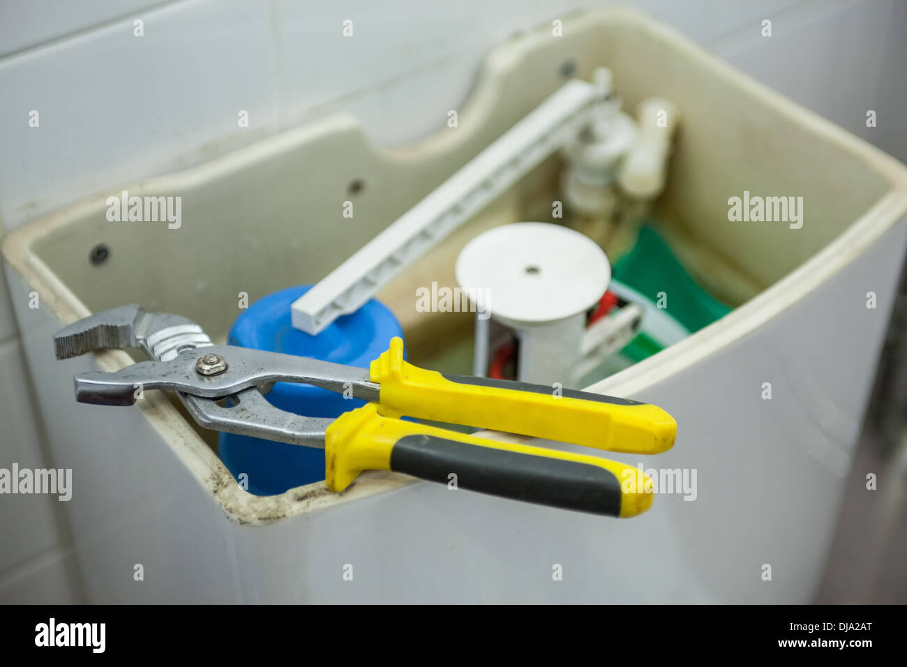 Close up of pliers lying on toilet Stock Photo Alamy