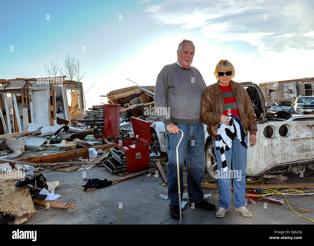 An elderly couple stands in front of their home destroyed by an EF-4 tornado November 19, 2013 in Washington, IL. The tornado left a path of destruction that stretched for more than 46 miles and damaged fourteen-hundred homes. Stock Photo