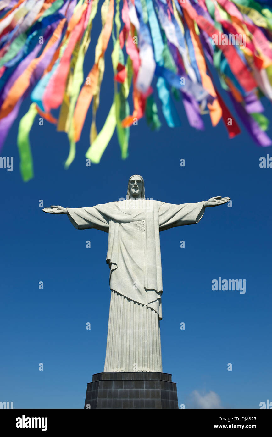 Rio Carnival celebration features colorful lembranca streamers at statue of Corcovado Stock Photo