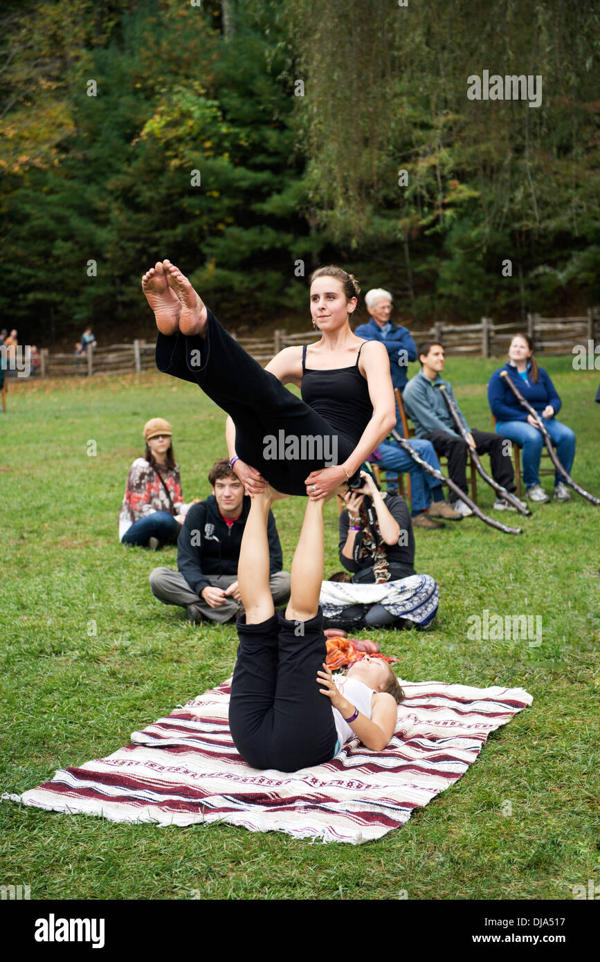Two ladies doing acrobatics at the Leaf Festival (Lake Eden Arts Festival) in Black Mountain North Carolina. Stock Photo