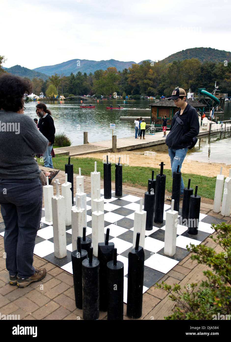 People playing chess on an oversize game board at the Leaf Festival