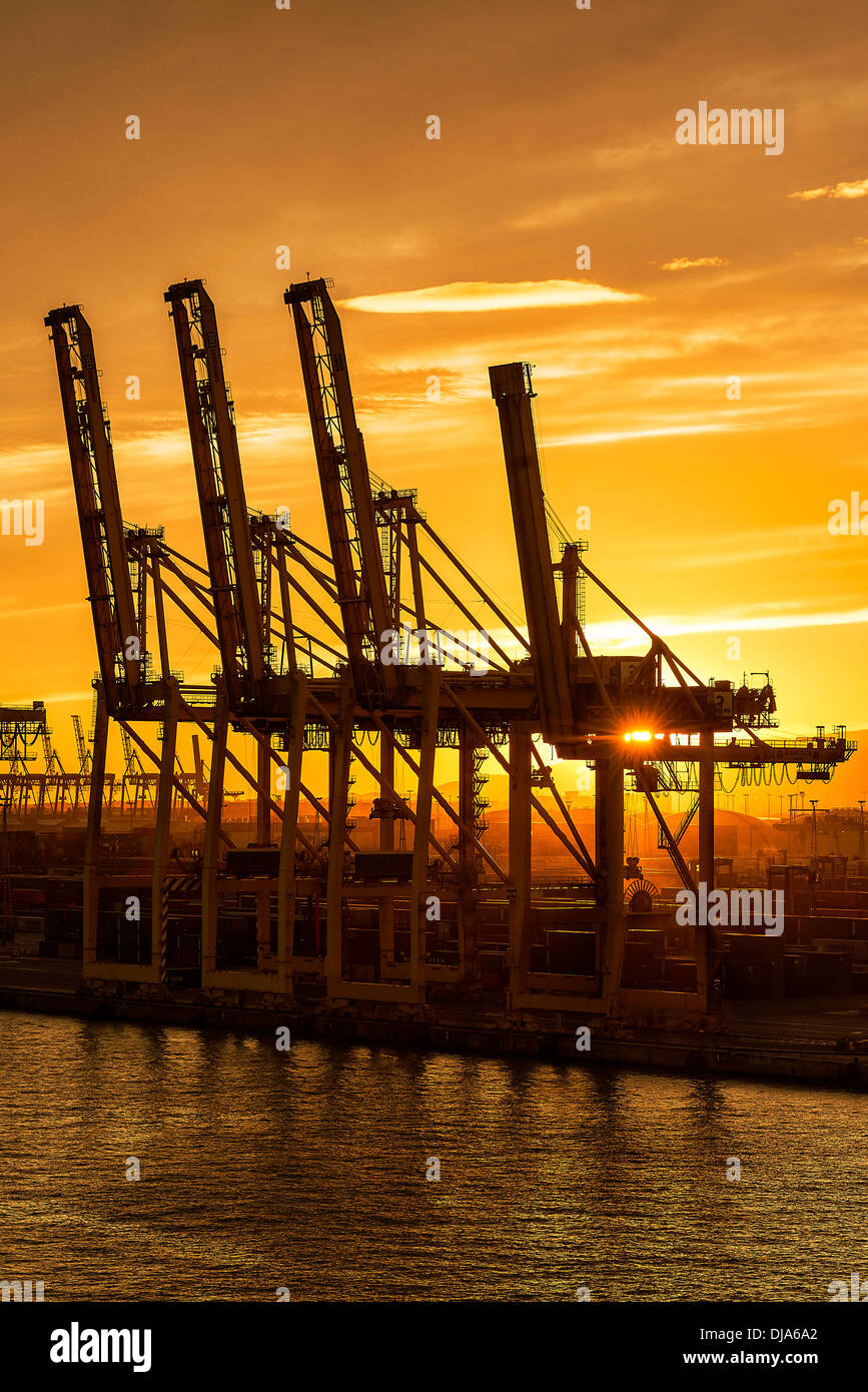 Cranes await a shipping freighter to load with cargo, Barcelona, Spain Stock Photo