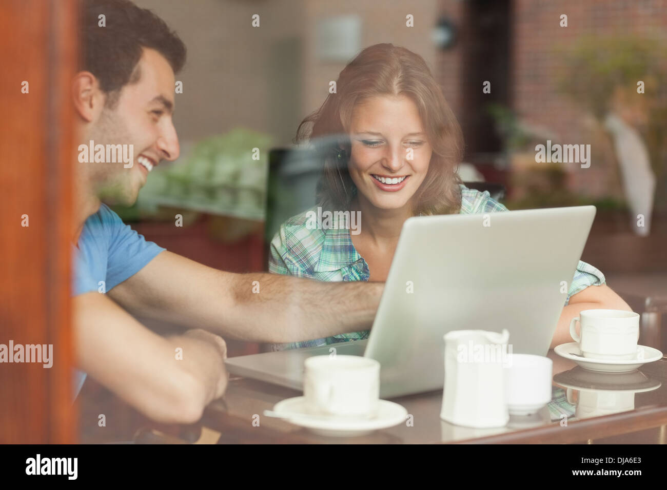 Two laughing students looking at laptop Stock Photo