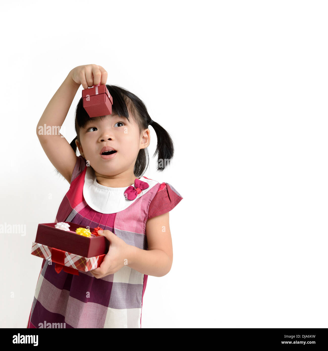Portrait of little girl lifting up gift box Stock Photo