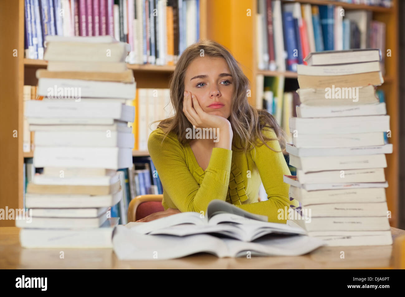 Frustrated female student pile books hi-res stock photography and ...