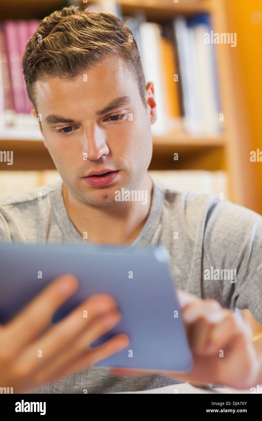 Attractive focused student using tablet Stock Photo