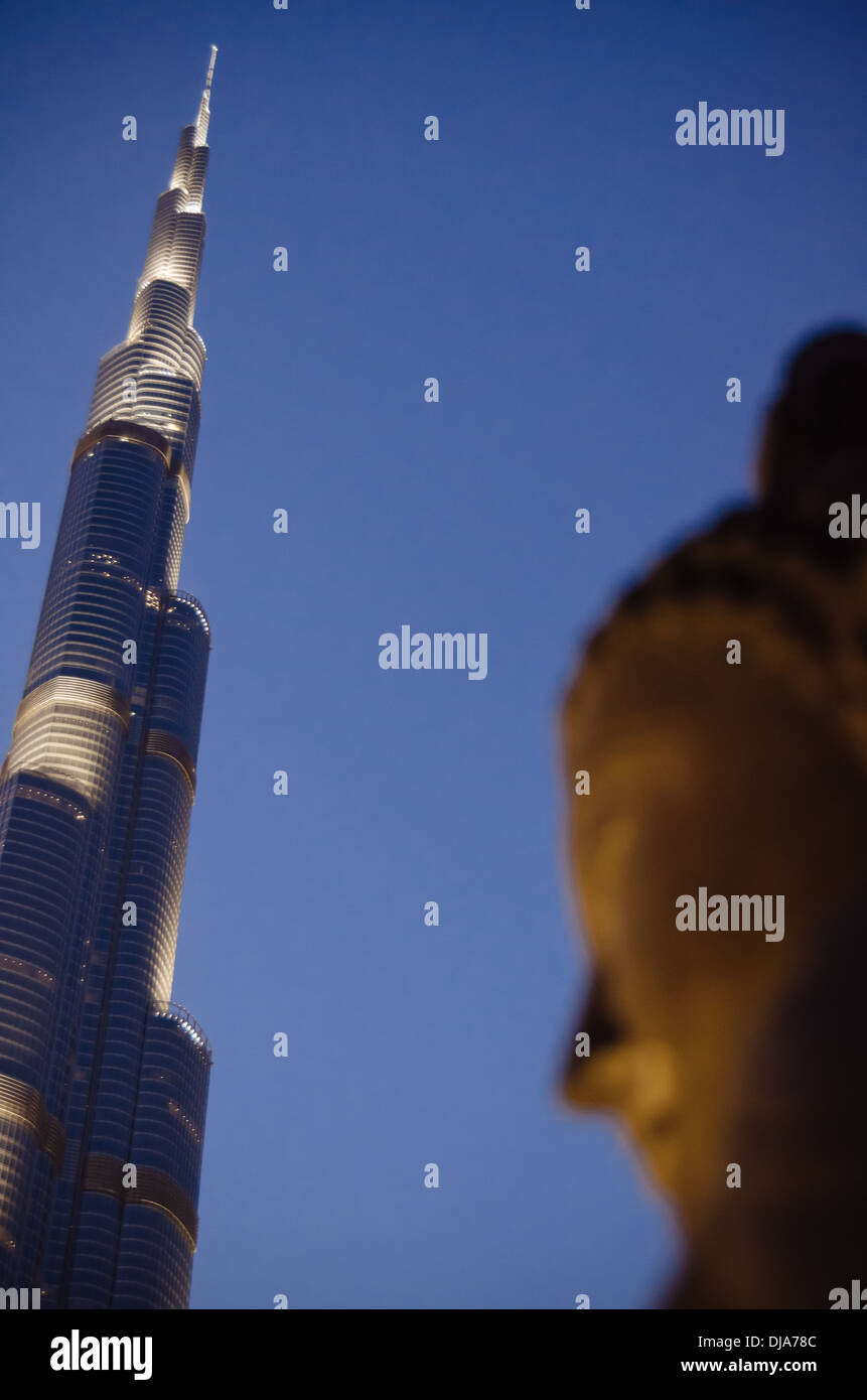 The Burj Khalifa with a Buddha statue in the foreground. Dubai, United