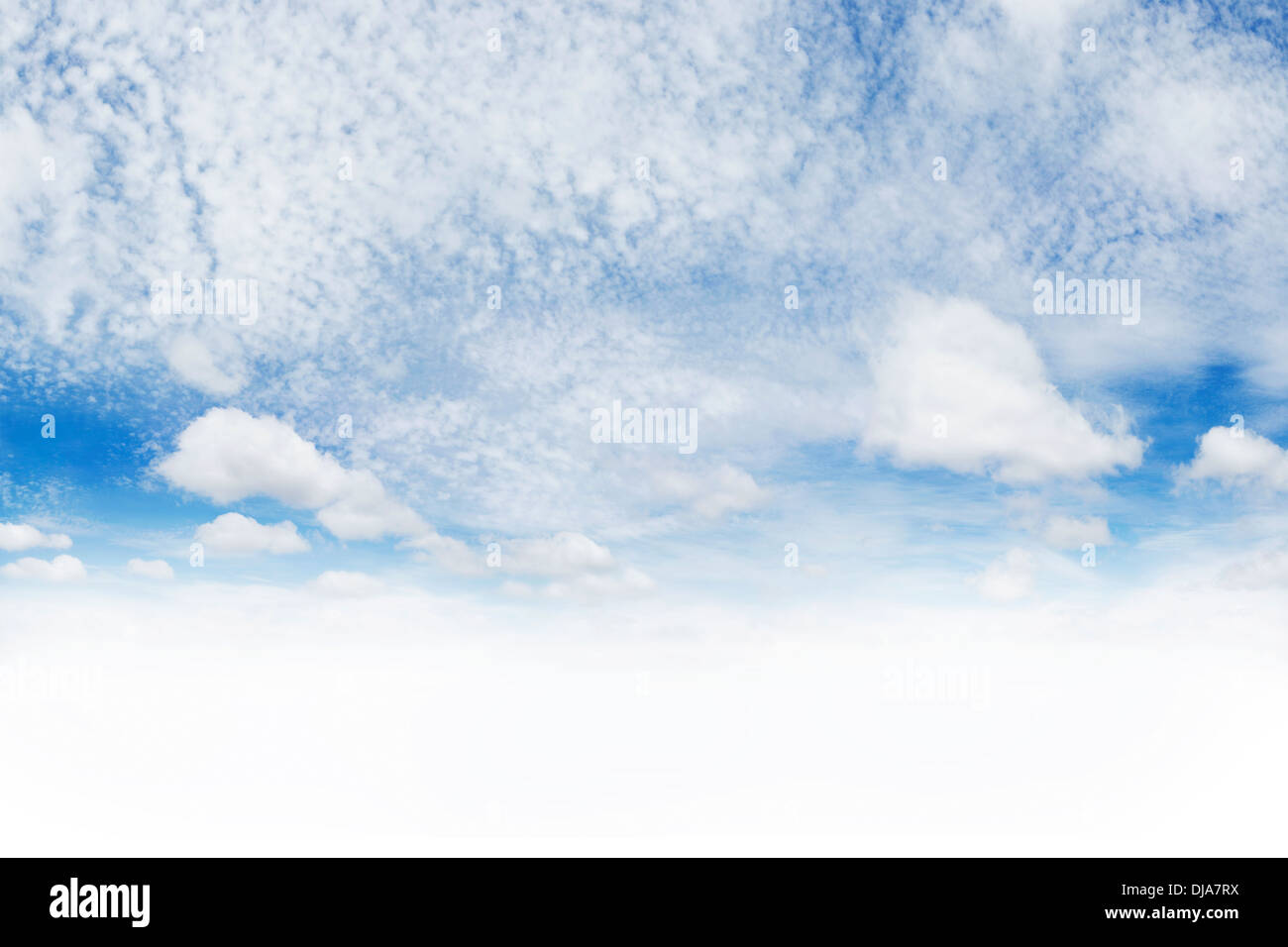 White fluffy clouds in blue sky. Copy space below Stock Photo