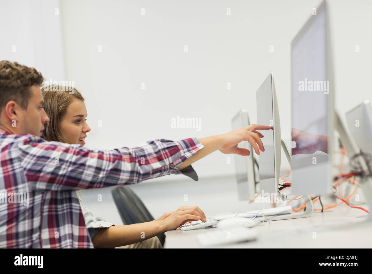 Two students typing pointing on hi-res stock photography and images - Alamy
