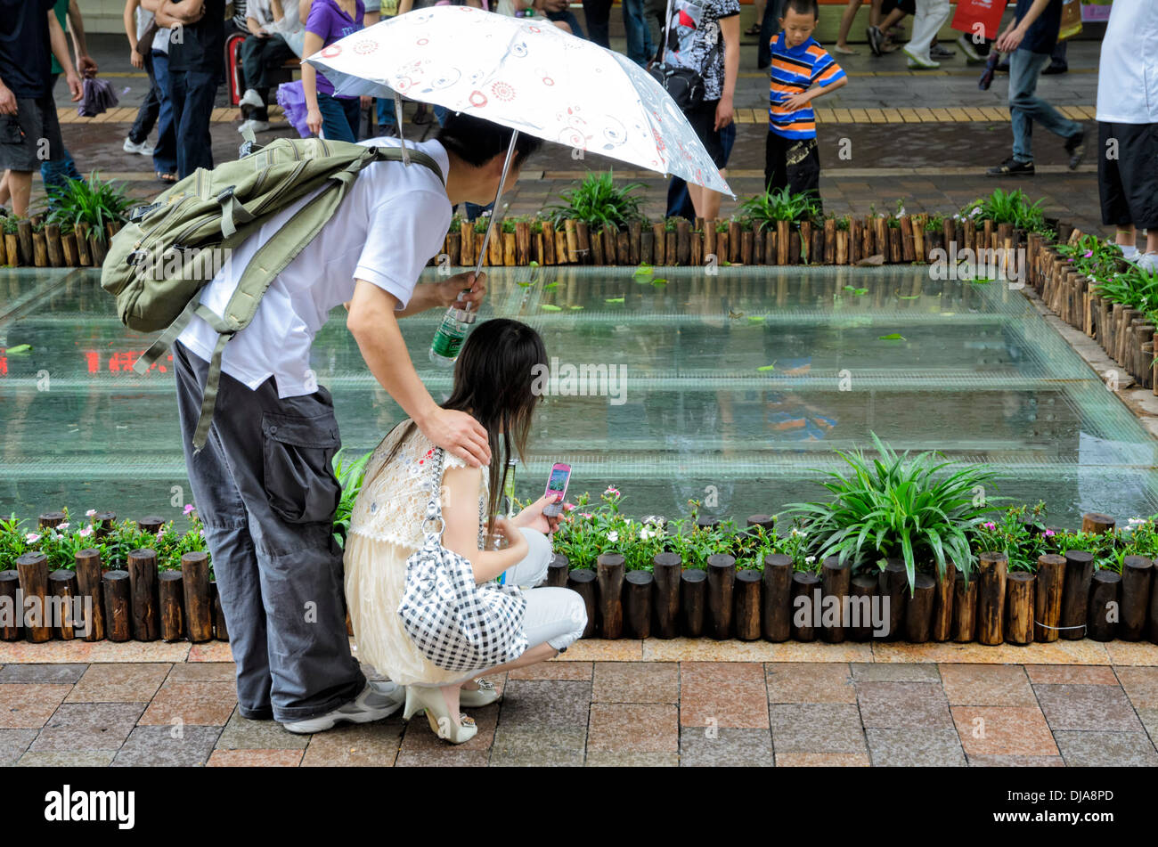 Chinese people stop to look at the preserved remains of an ancient street in China Stock Photo