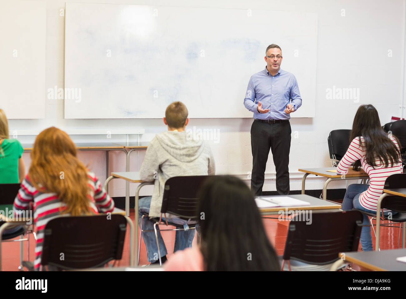 Attentive students with teacher in the classroom Stock Photo