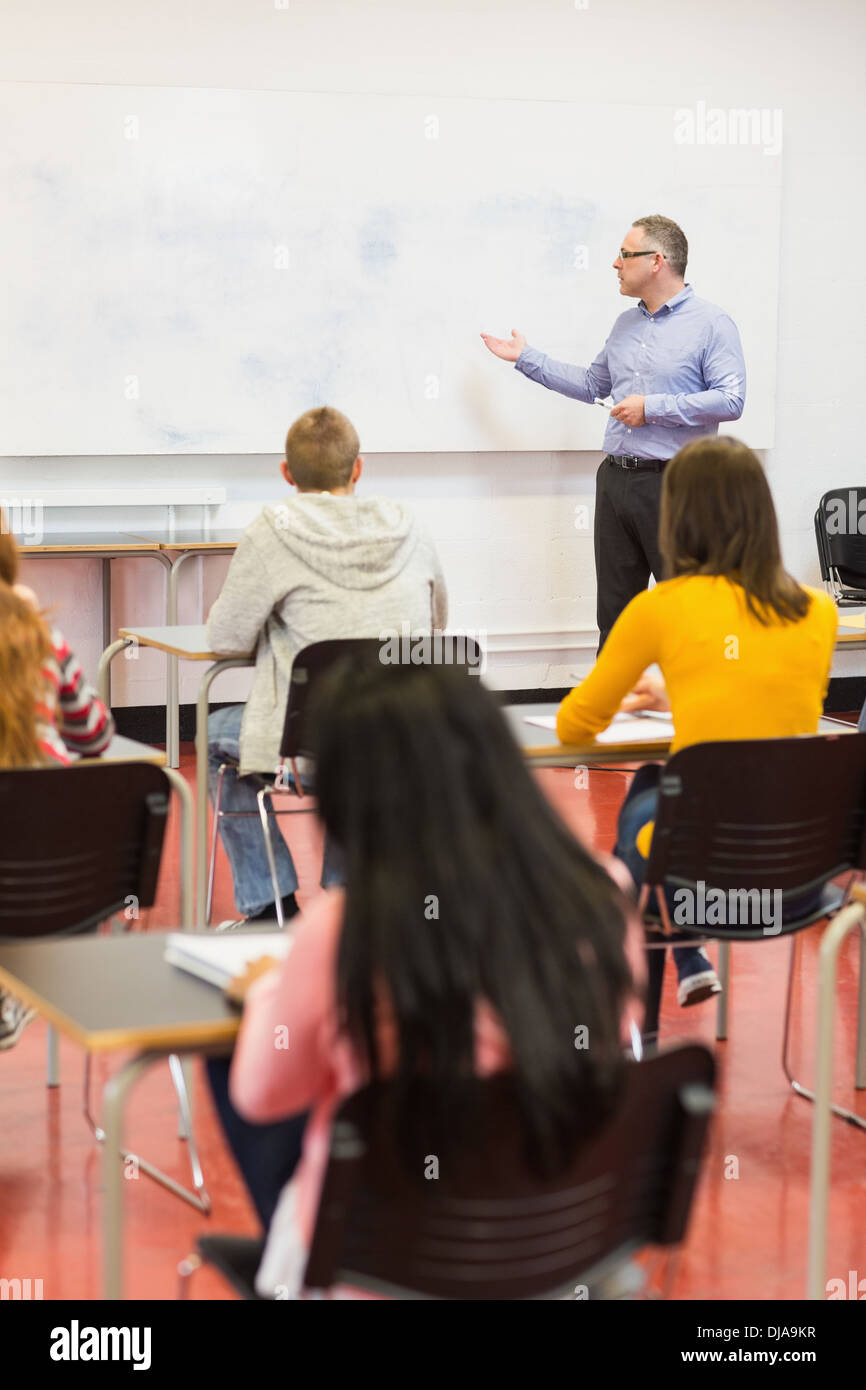 Attentive students with teacher in the classroom Stock Photo