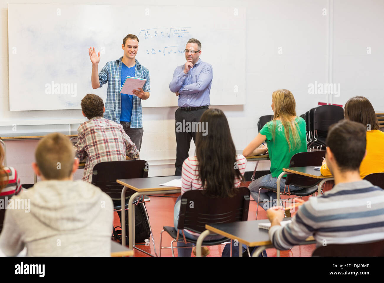 Teacher with students in the classroom Stock Photo - Alamy