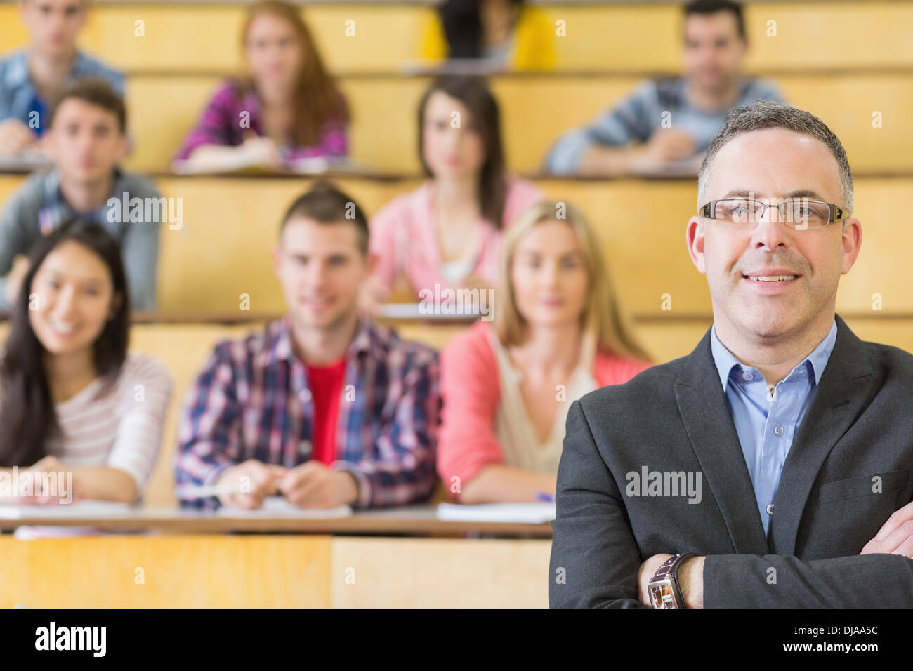 Elegant teacher with students sitting at lecture hall Stock Photo