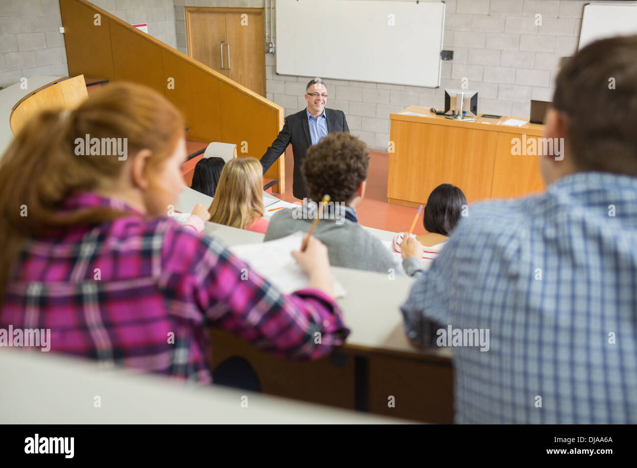 Teacher with students at the lecture hall Stock Photo