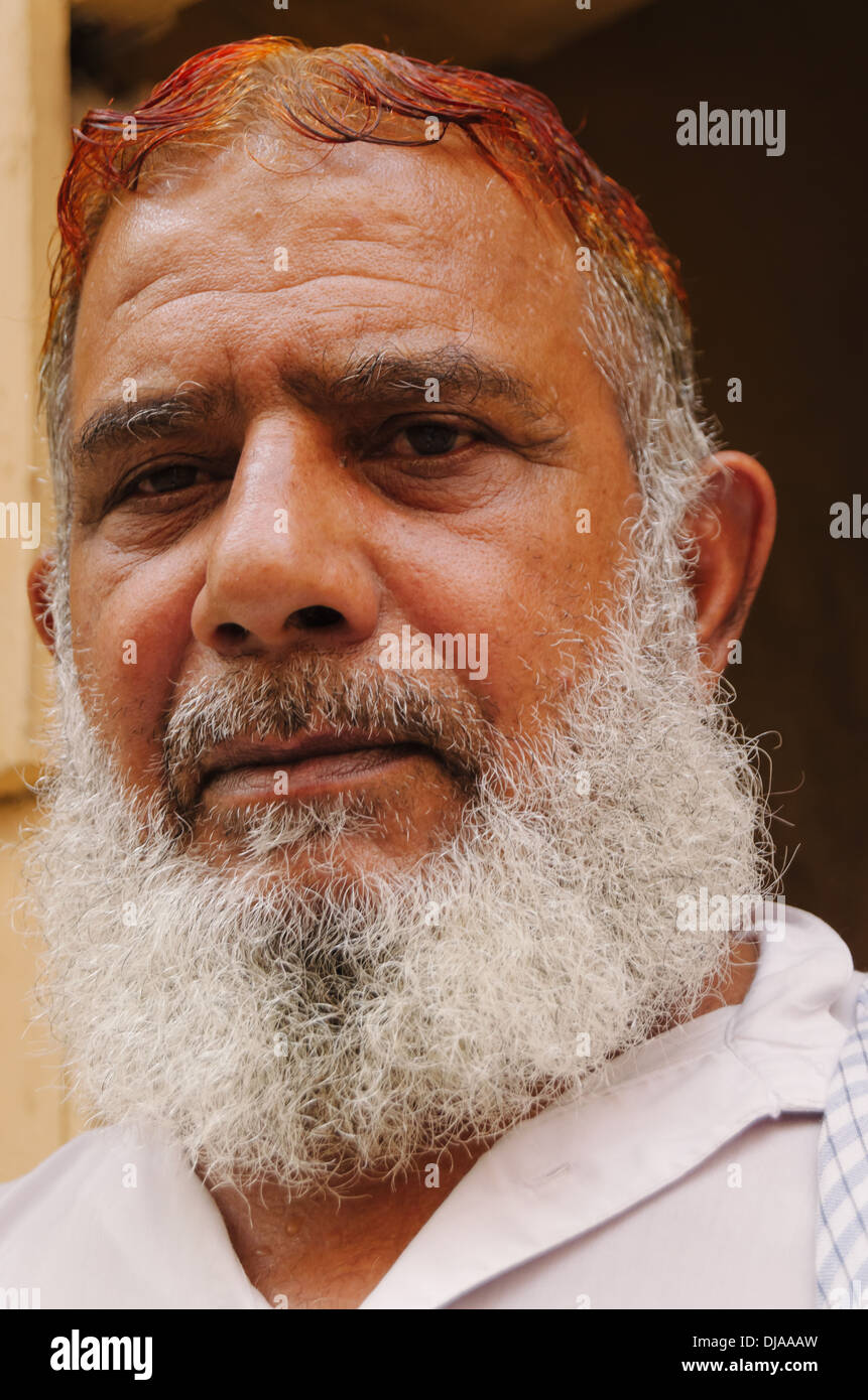 Portrait of Arab man with red hair and gray beard in the streets of Deira. Dubai, United Arab Emirates. Stock Photo