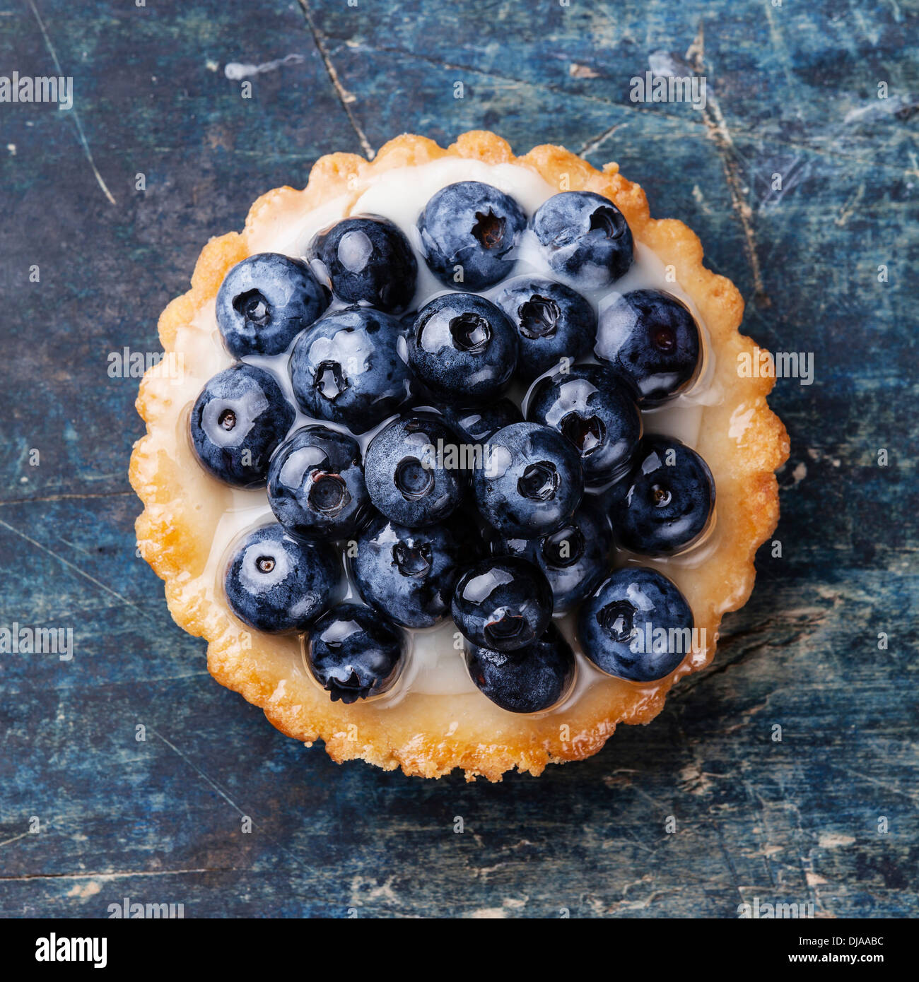 Blueberry tart on blue wooden background Stock Photo